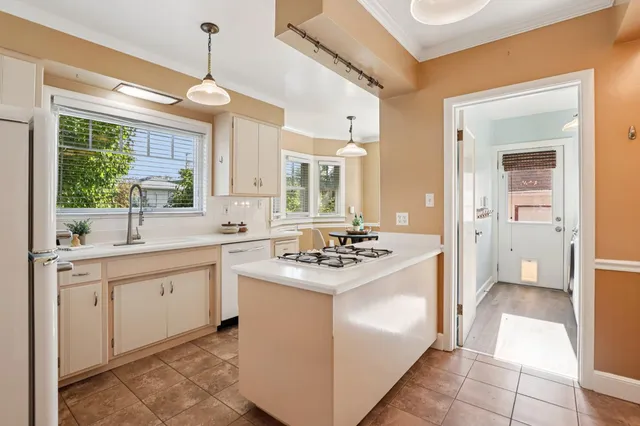 a kitchen with white cabinets and white appliances