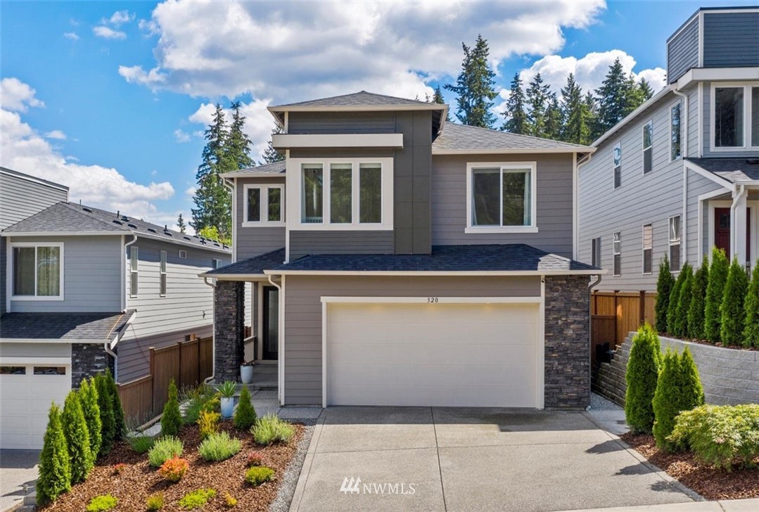 320 181st Street Southeast Bothell, WA 98012 - Photo 1 of 40 a view of a white house with large windows and a small yard