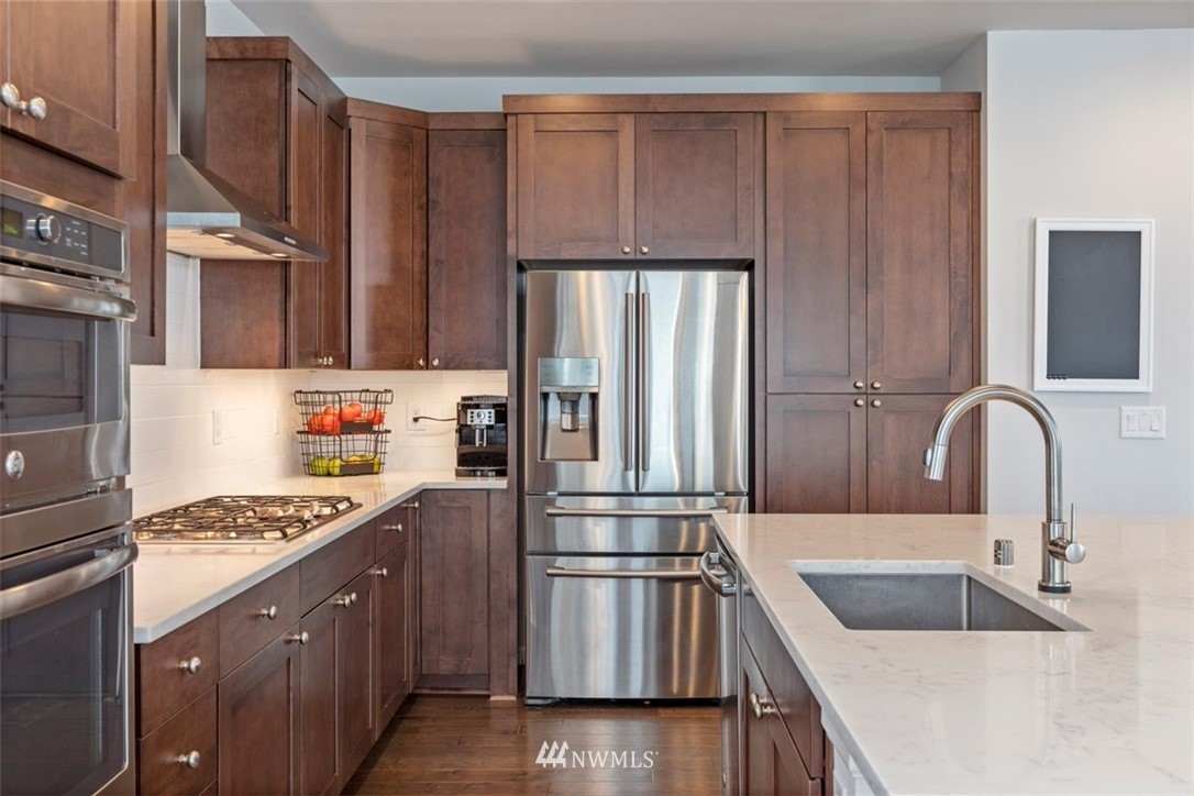 320 181st Street Southeast Bothell, WA 98012 - Photo 11 of 40 a kitchen with granite countertop a refrigerator stove and sink