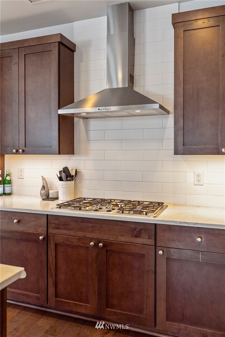 320 181st Street Southeast Bothell, WA 98012 - Photo 12 of 40 a kitchen with granite countertop a sink and cabinets