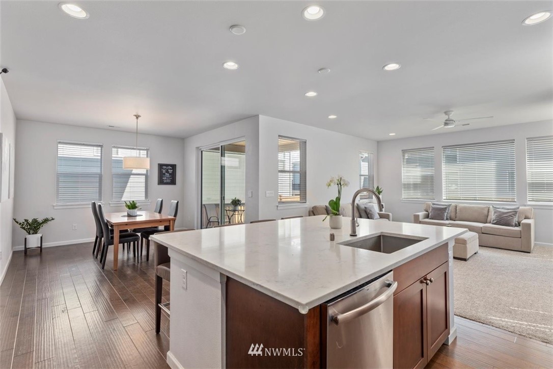 320 181st Street Southeast Bothell, WA 98012 - Photo 13 of 40 a large kitchen with kitchen island a dining table chairs and a wooden floor