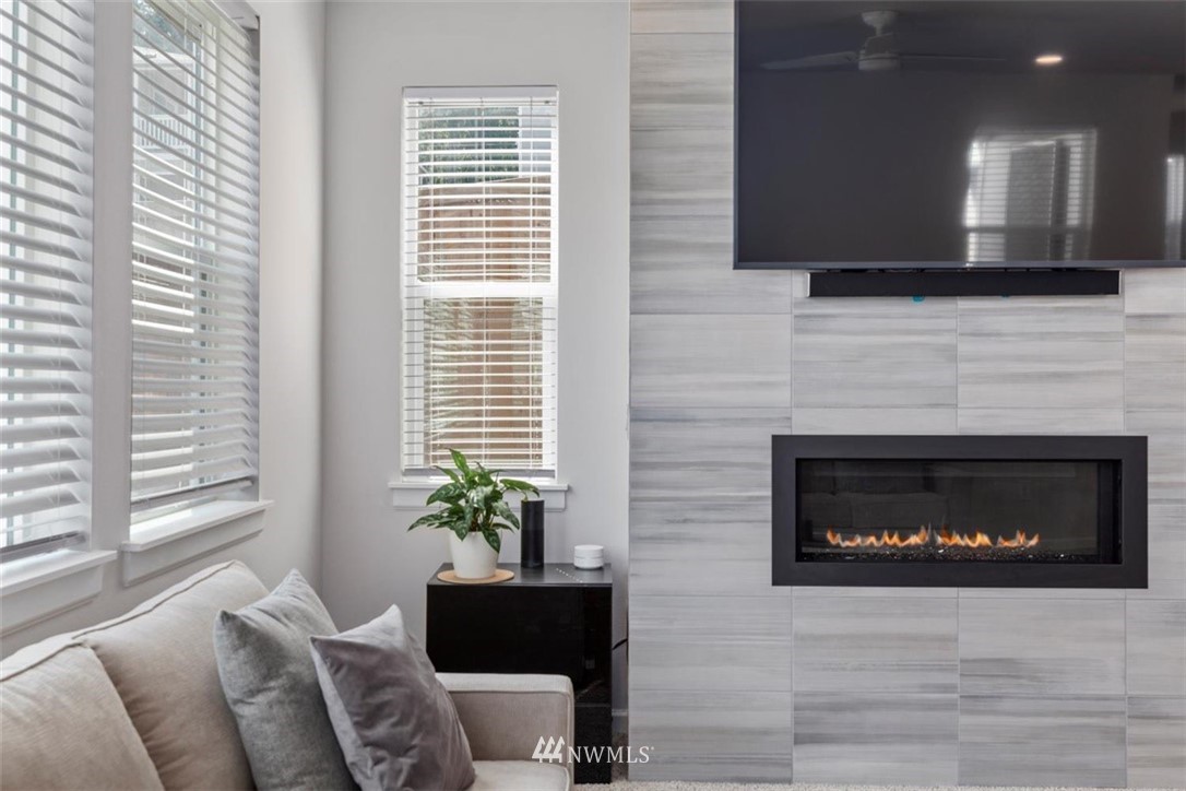 320 181st Street Southeast Bothell, WA 98012 - Photo 17 of 40 a living room with furniture a fireplace and a potted plant