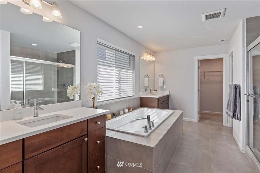 320 181st Street Southeast Bothell, WA 98012 - Photo 24 of 40 a bathroom with a sink double vanity granite and a shower