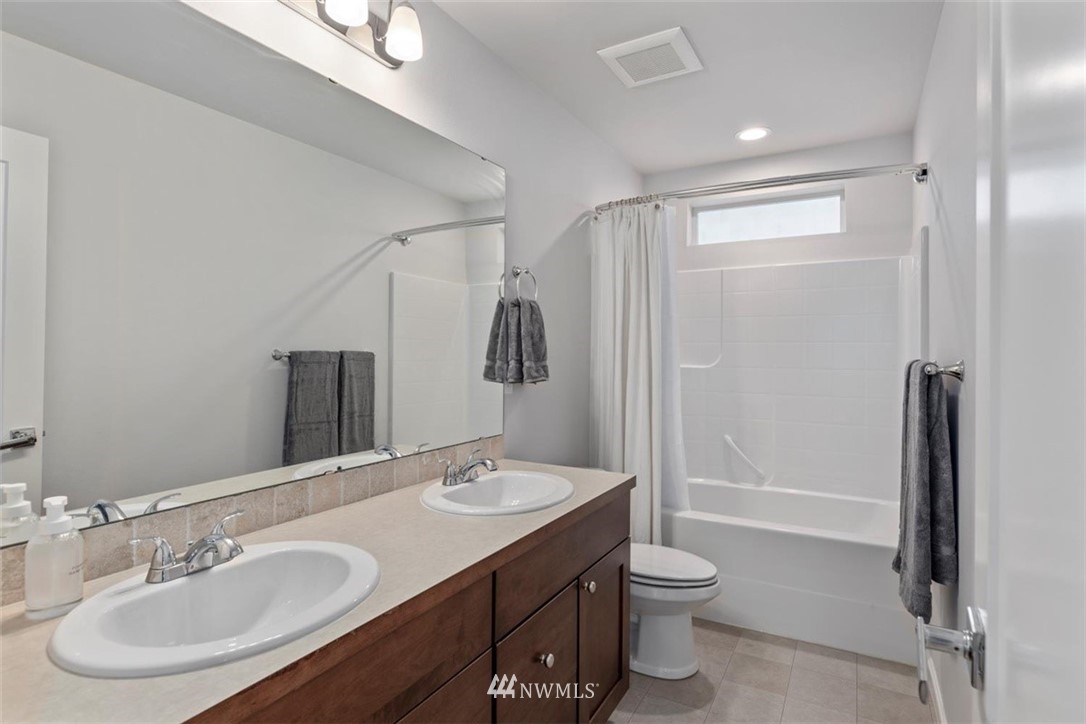 320 181st Street Southeast Bothell, WA 98012 - Photo 31 of 40 a bathroom with a granite countertop sink toilet and shower
