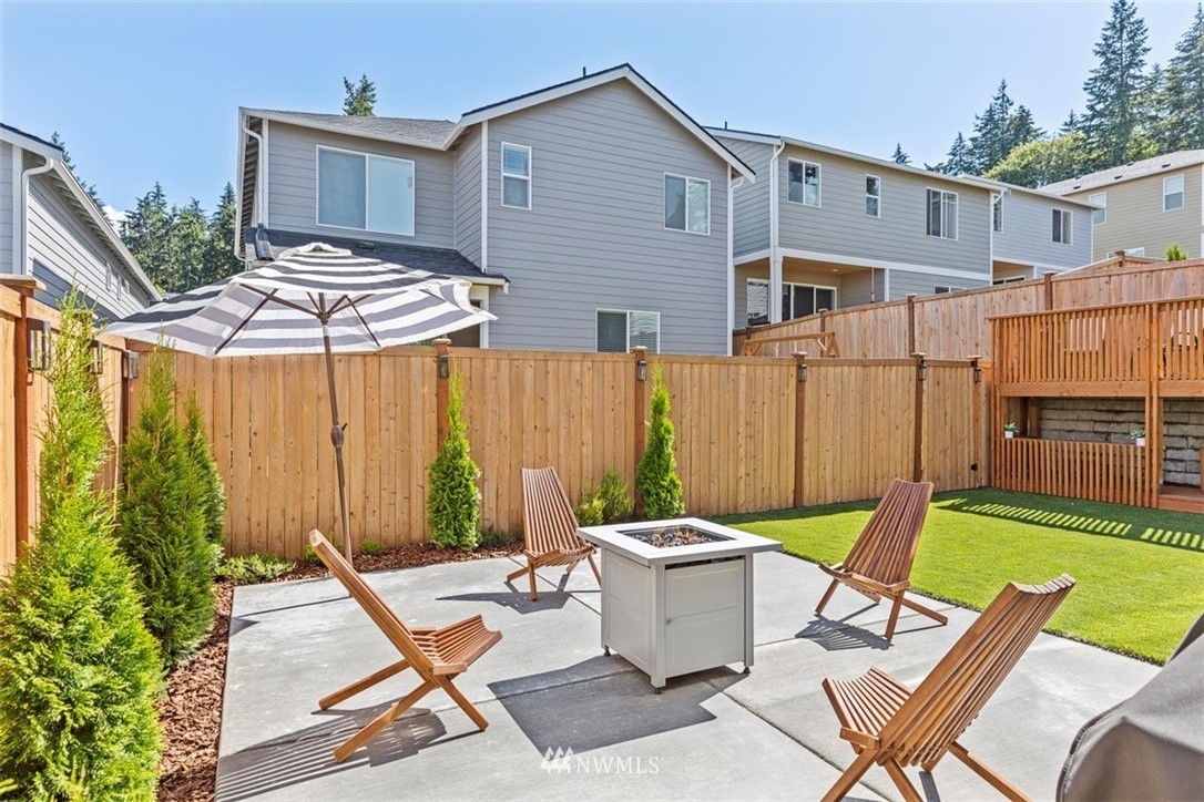 320 181st Street Southeast Bothell, WA 98012 - Photo 33 of 40 a view of a patio with table and chairs with wooden fence and plants