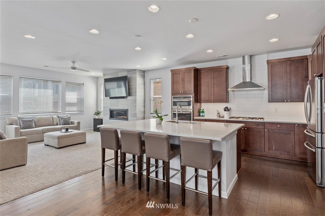 320 181st Street Southeast Bothell, WA 98012 - Photo 9 of 40 a kitchen with stainless steel appliances granite countertop a stove a sink a dining table and chairs