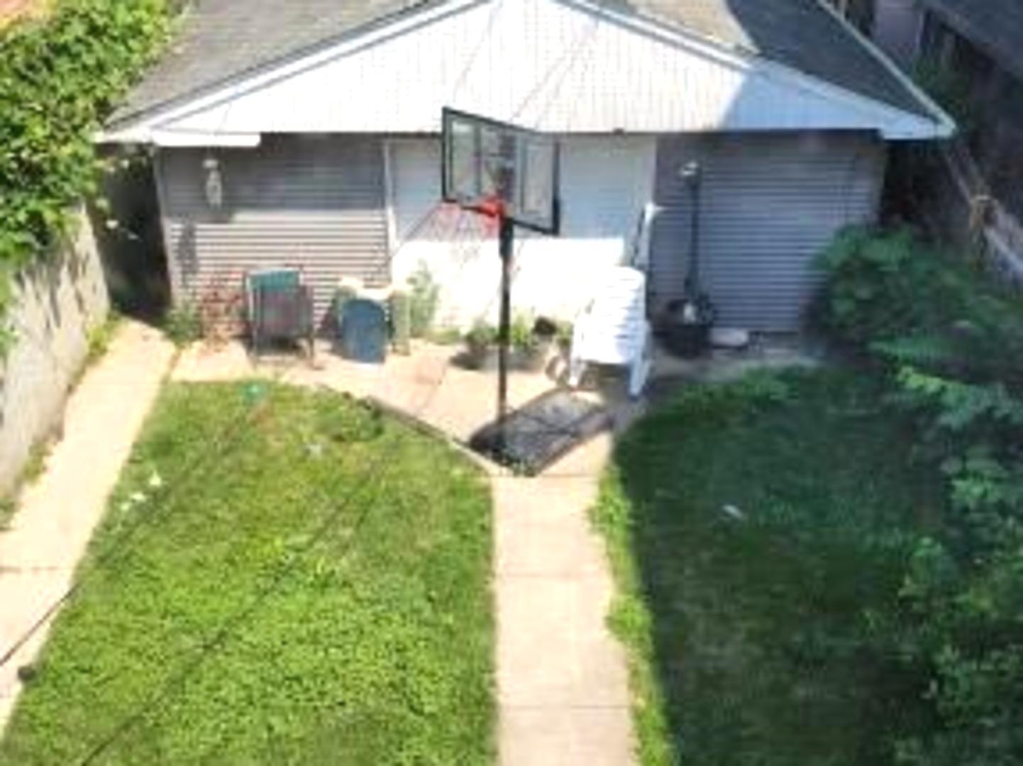 Undisclosed Address Chicago, IL 60641 - Photo 15 of 20 a front view of a house with garden