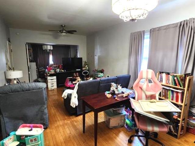 Undisclosed Address Chicago, IL 60641 - Photo 3 of 20 a living room with furniture and a chandelier