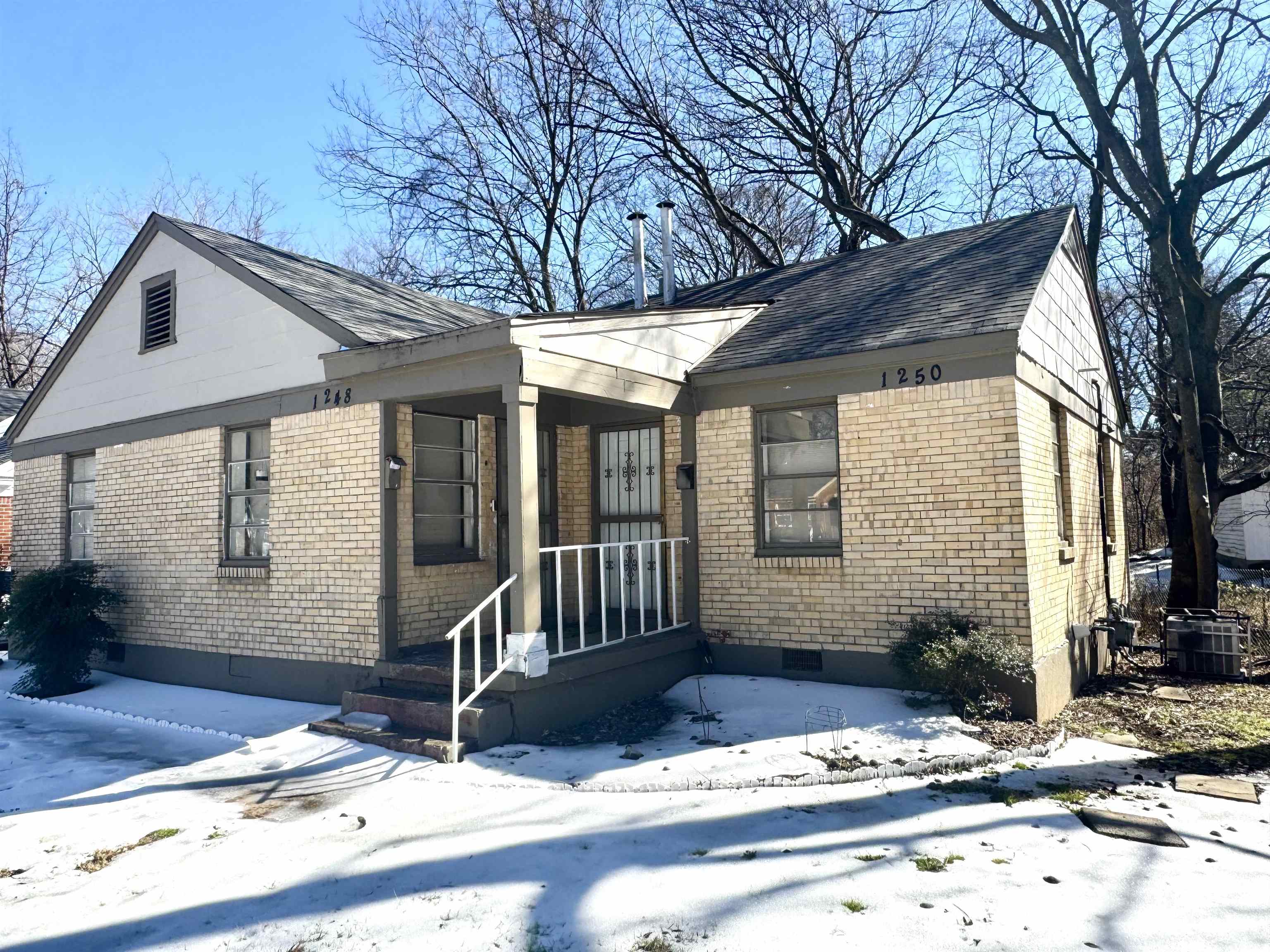 View of front of property featuring brick siding and crawl space