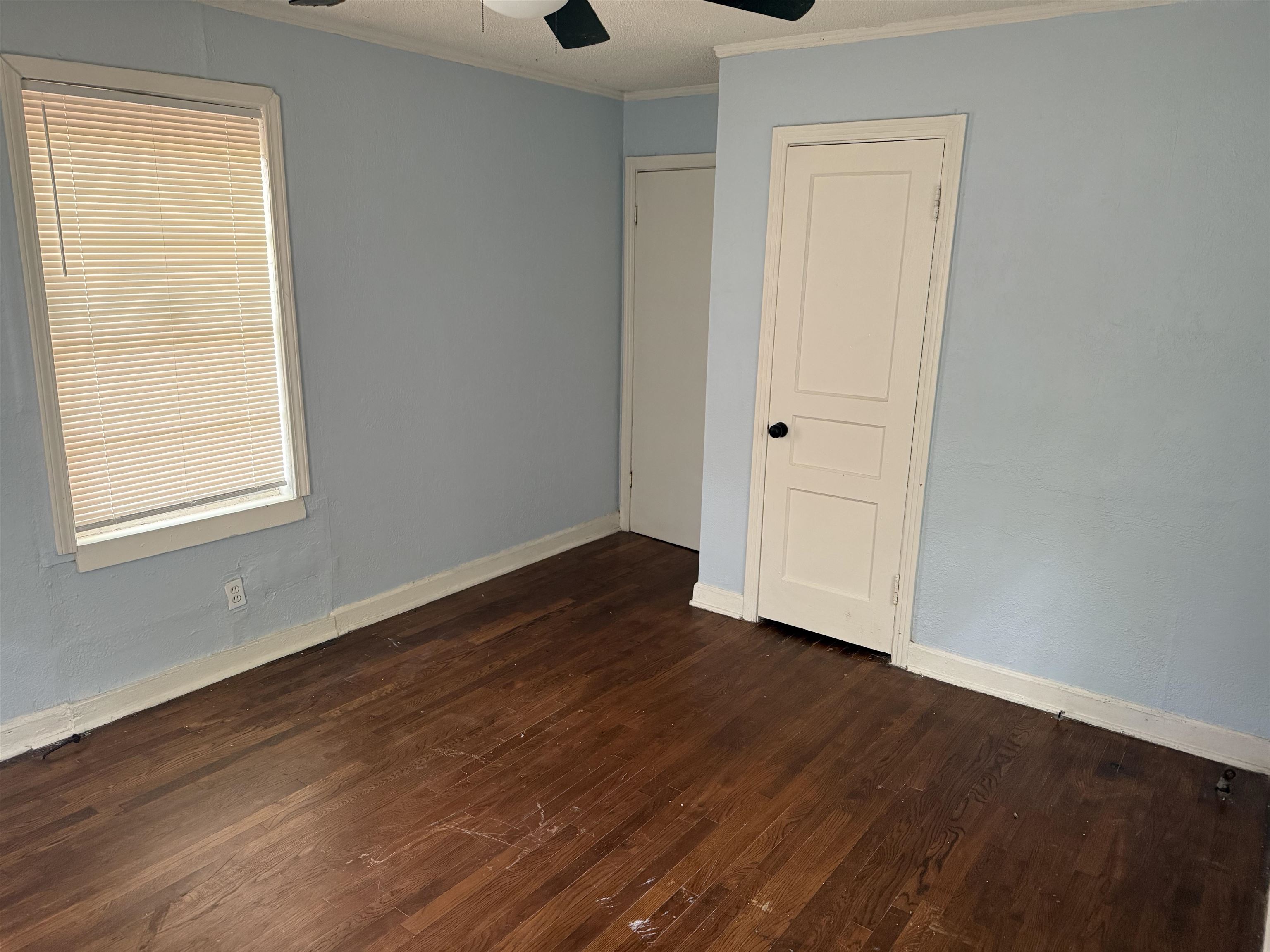 1248 Meda Street Memphis, TN 38114 - Photo 11 of 24 Unfurnished bedroom featuring dark wood finished floors, ornamental molding, and a ceiling fan