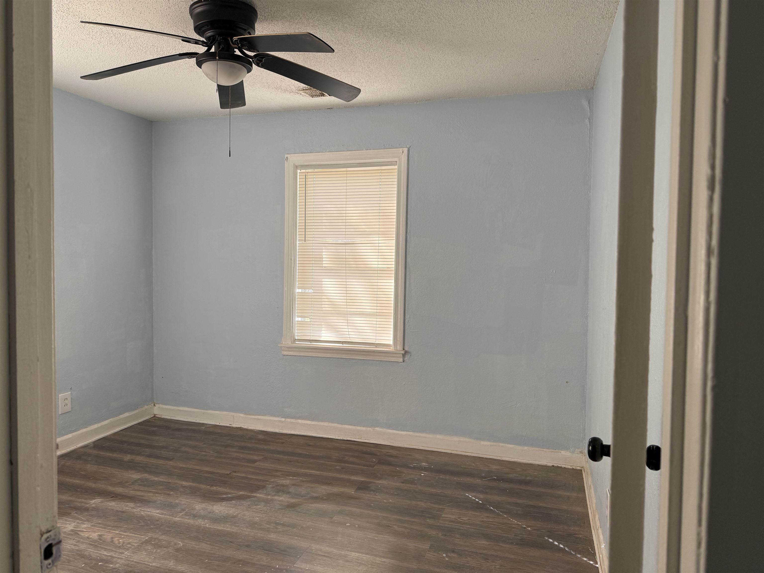 1248 Meda Street Memphis, TN 38114 - Photo 23 of 24 Unfurnished room with dark wood finished floors, a textured ceiling, and a ceiling fan