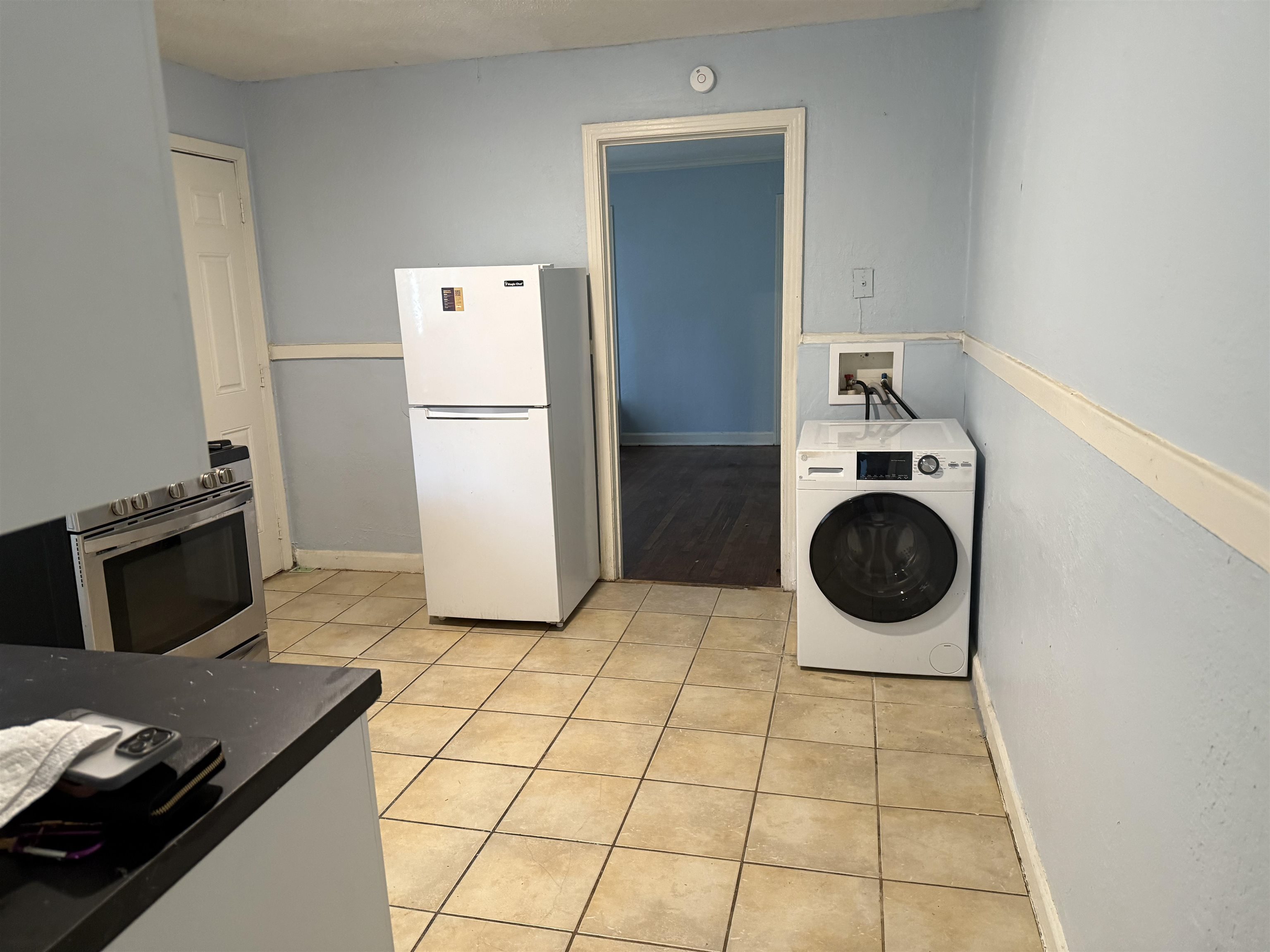 1248 Meda Street Memphis, TN 38114 - Photo 8 of 24 Laundry area featuring washer / dryer and light tile patterned floors