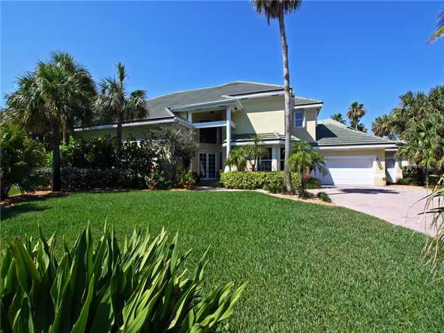3000 Southeast Island Point Lane Stuart, FL 34996 - Photo 1 of 25 a front view of a house with garden