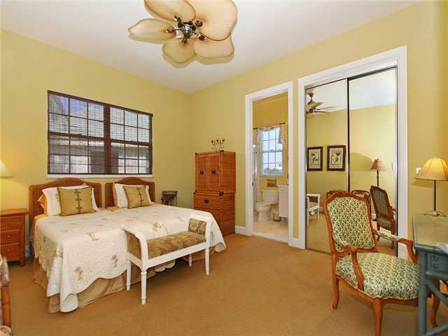 3000 Southeast Island Point Lane Stuart, FL 34996 - Photo 11 of 25 a bedroom with a bed chairs and window