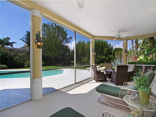 3000 Southeast Island Point Lane Stuart, FL 34996 - Photo 12 of 25 a view of a patio with couches potted plants and a big yard