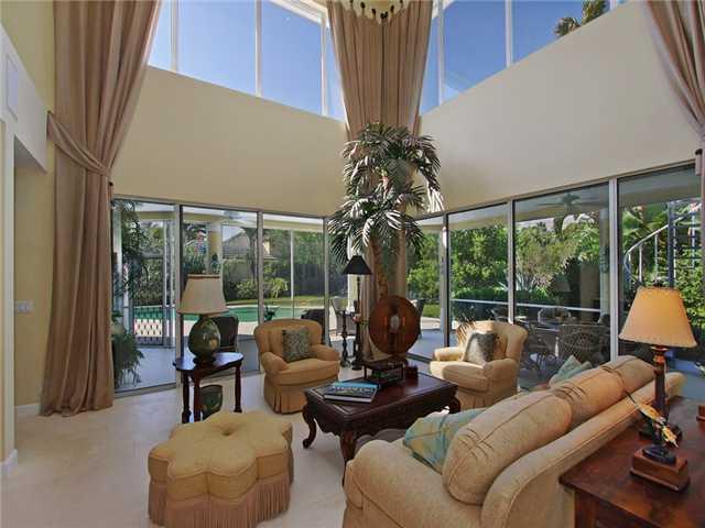 3000 Southeast Island Point Lane Stuart, FL 34996 - Photo 2 of 25 a living room with furniture a lamp and a large window