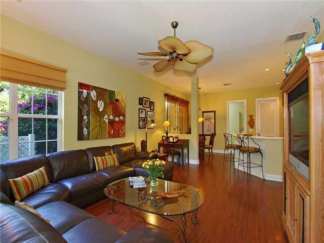 3000 Southeast Island Point Lane Stuart, FL 34996 - Photo 7 of 25 a living room with furniture a dining table and a chandelier