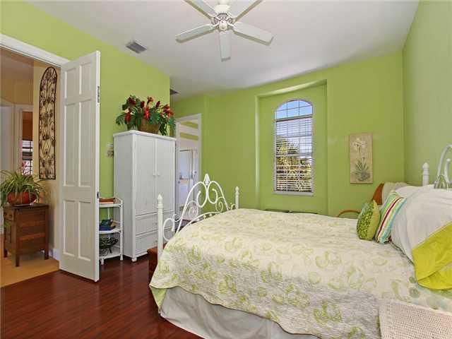 3000 Southeast Island Point Lane Stuart, FL 34996 - Photo 10 of 25 a bedroom with a bed dresser and a window