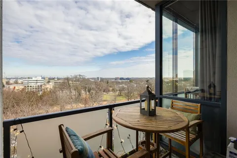 a view of a balcony with table and chairs
