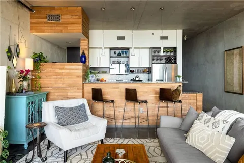 a living room with furniture and a kitchen area