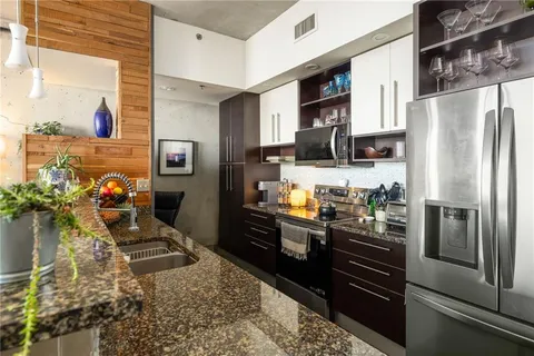 a kitchen with a refrigerator and a sink