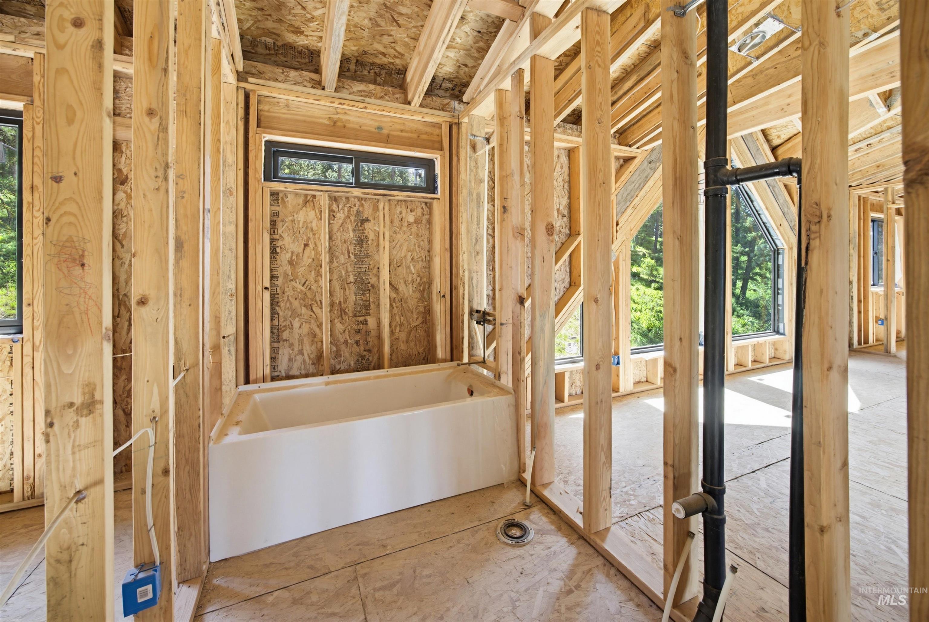 3322 Big Creek Road New Meadows, ID 83654 - Photo 24 of 50 Construction framing showcasing a built-in tub with a horizontal window above