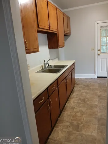 a kitchen with sink a microwave a stove and refrigerator
