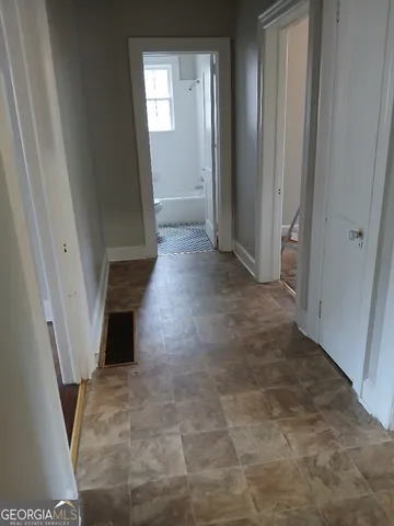 a bathroom with a granite countertop toilet sink and mirror