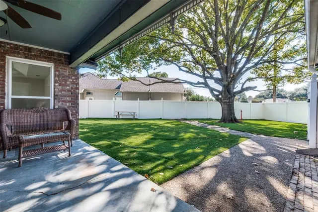 a view of a house with backyard and a tree