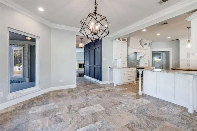 a view of a kitchen with a sink and refrigerator