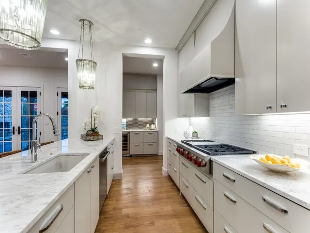 a kitchen with stainless steel appliances a sink stove and cabinets