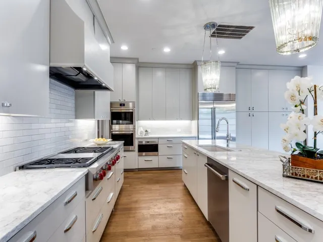 a large kitchen with stainless steel appliances granite countertop a stove and a sink