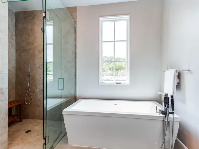 a bathroom with a bathtub and shower