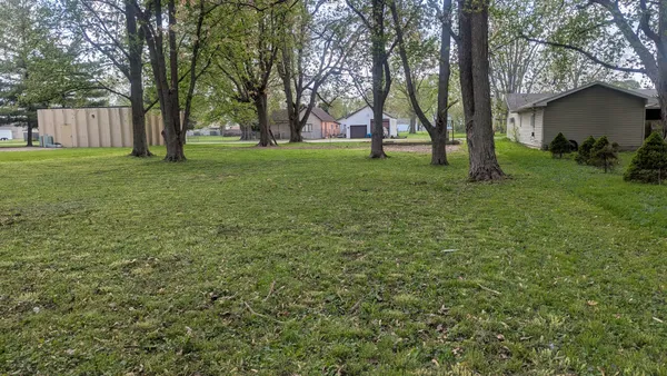 a view of a backyard with large trees