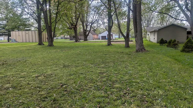 a view of a backyard with large trees