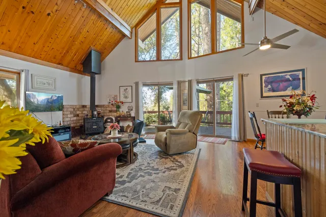 a living room with furniture a couch and paintings on the wall
