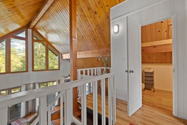 a view of an entryway with wooden floor and door