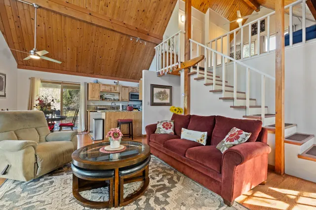 a living room with fireplace furniture and a rug