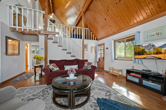 a living room with fireplace furniture and a window