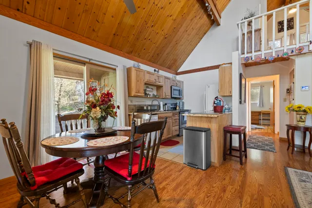 a dining room with furniture and wooden floor