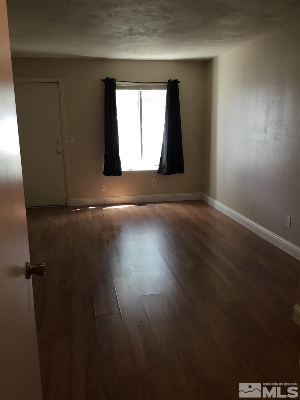 2366 Roundhouse Road Sparks, NV 89431 - Photo 11 of 13 an empty room with wooden floor and windows