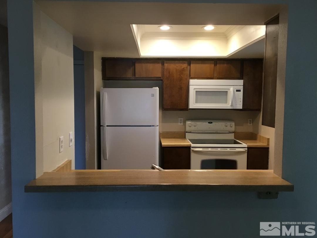 2366 Roundhouse Road Sparks, NV 89431 - Photo 3 of 13 a kitchen with a refrigerator and a stove