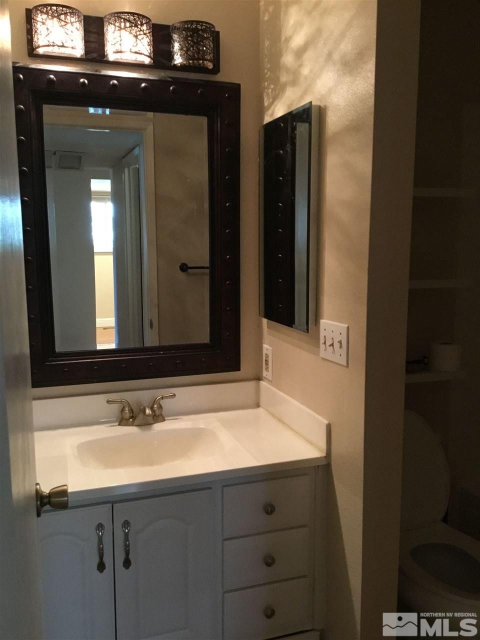 2366 Roundhouse Road Sparks, NV 89431 - Photo 7 of 13 a bathroom with a sink and a mirror