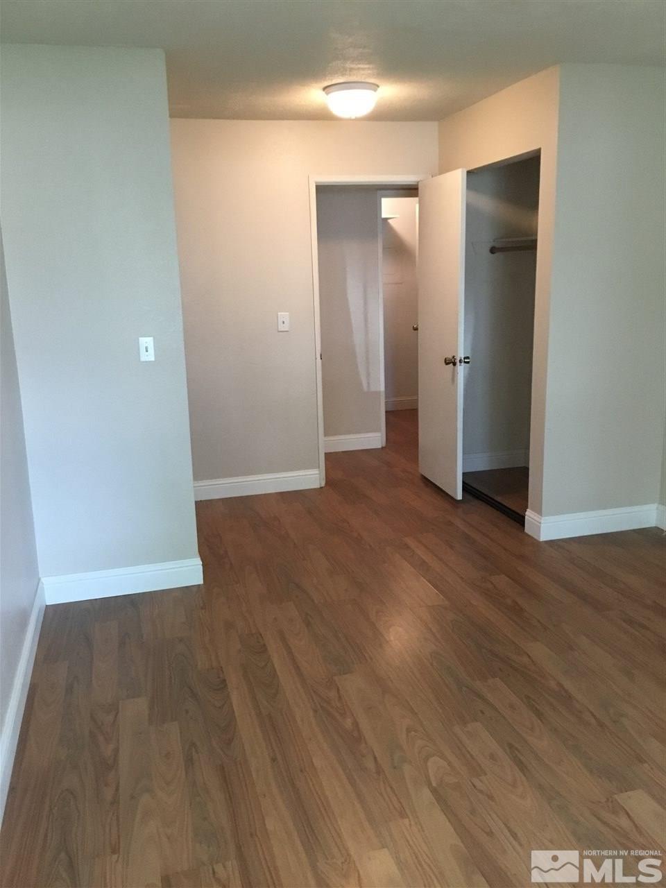 2366 Roundhouse Road Sparks, NV 89431 - Photo 9 of 13 an empty room with wooden floor and closet