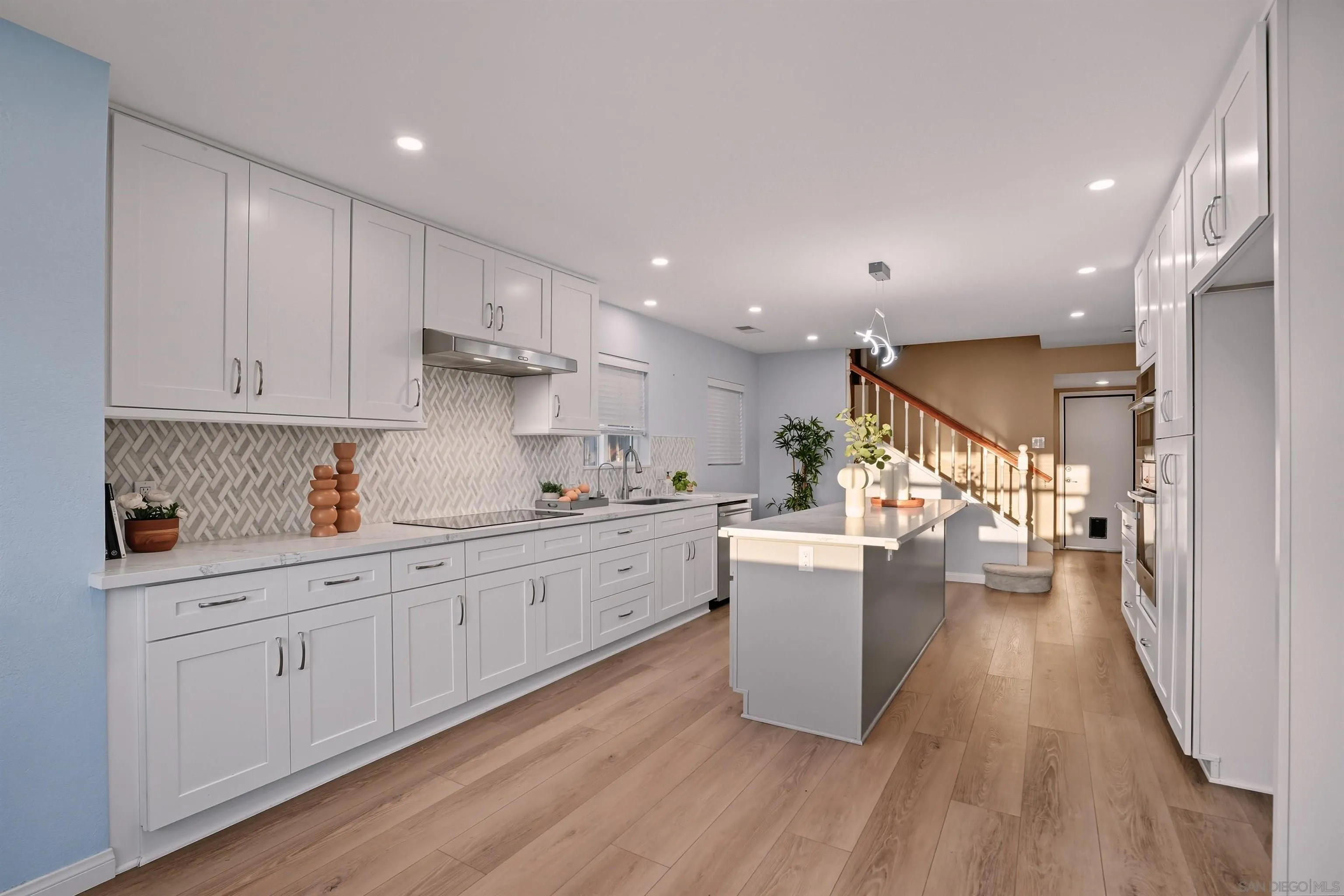 14704 Carmel Ridge Road San Diego, CA 92128 - Photo 3 of 22 a kitchen with sink cabinets and wooden floor