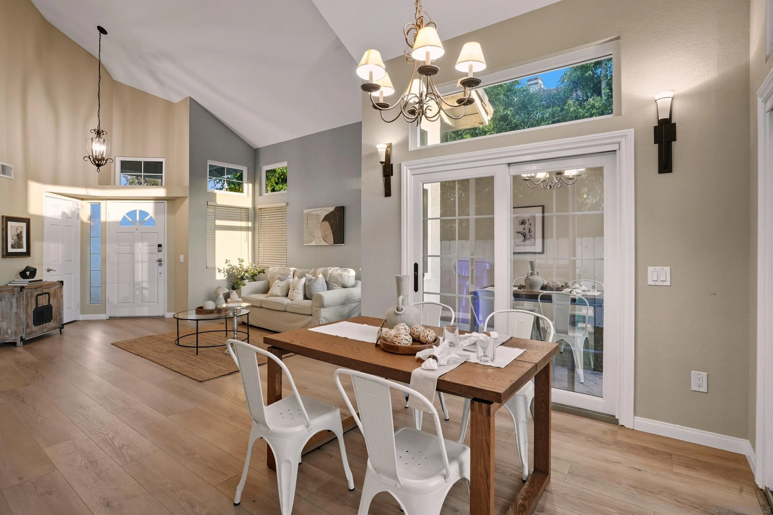 14704 Carmel Ridge Road San Diego, CA 92128 - Photo 7 of 22 a view of a dining room with furniture a chandelier and wooden floor