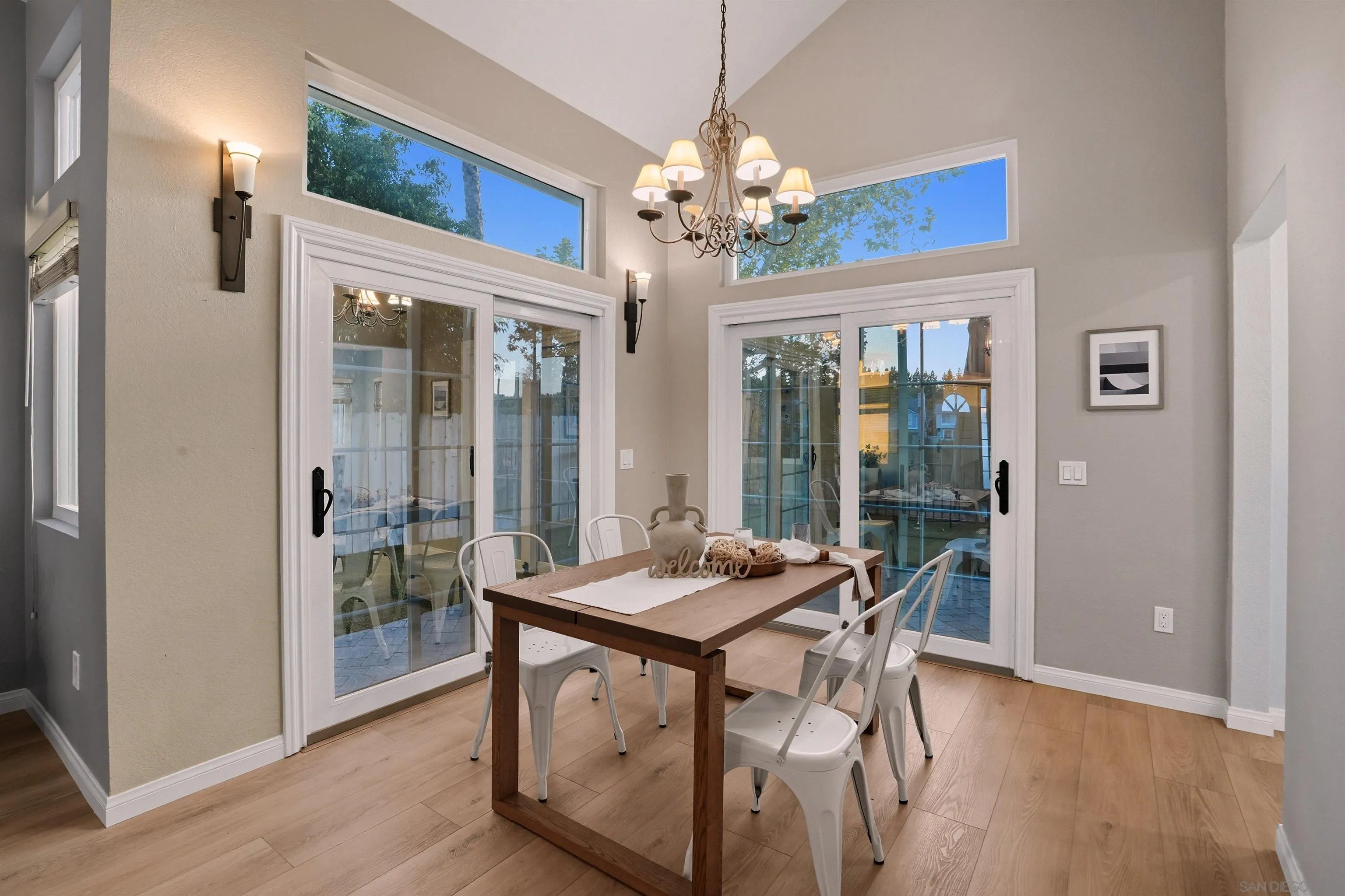 14704 Carmel Ridge Road San Diego, CA 92128 - Photo 8 of 22 a view of a dining room with furniture wooden floor and chandelier