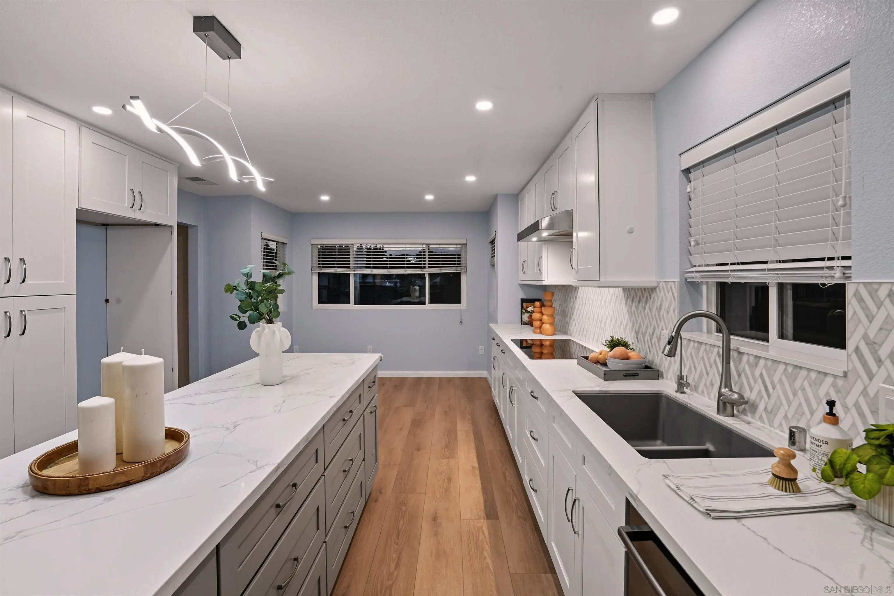 14704 Carmel Ridge Road San Diego, CA 92128 - Photo 9 of 22 a kitchen with a sink stove and wooden floor