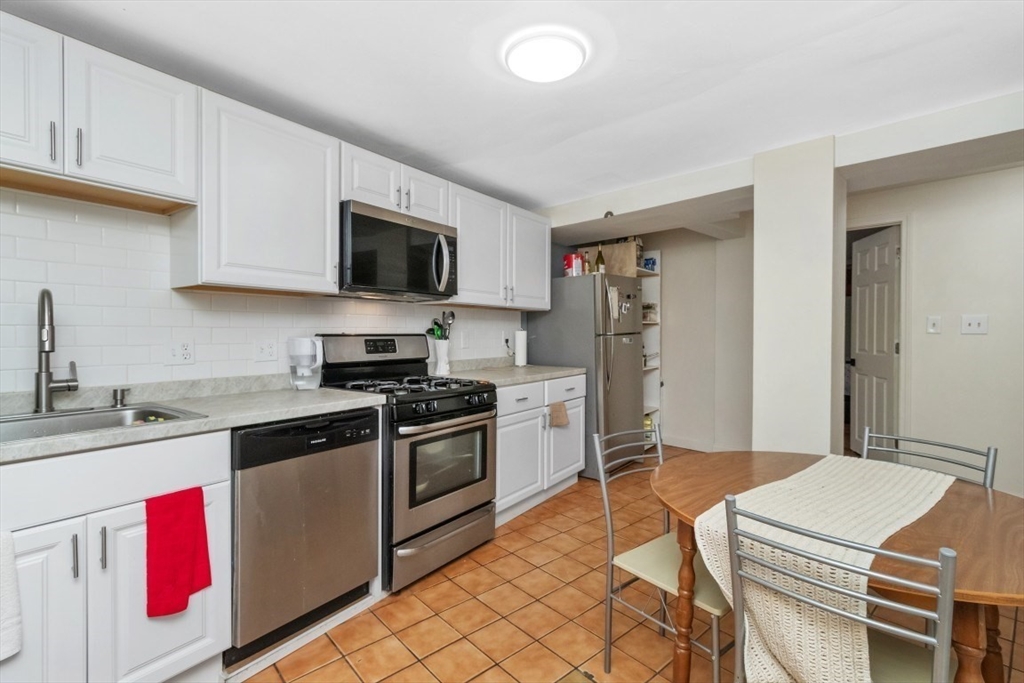 8 Colliston Road Boston, MA 02135 - Photo 24 of 40 a kitchen with a sink stove and microwave