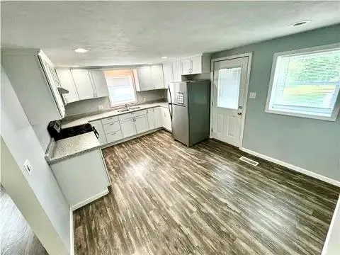 a kitchen with stainless steel appliances a refrigerator and a stove top oven